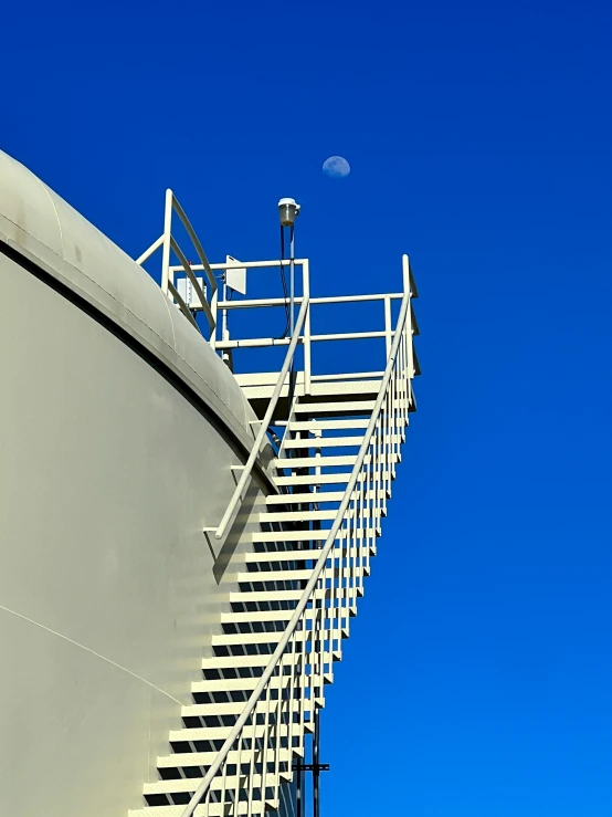 a white railing and a blue sky