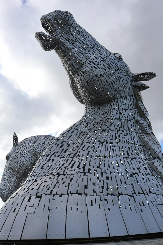 a very large statue made up of metal dogs