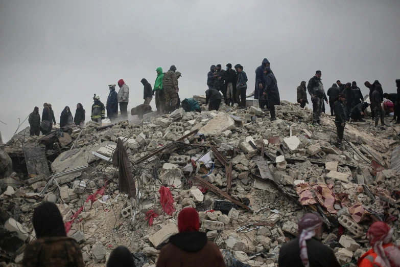 the people are standing on the top of a rocky outcrop