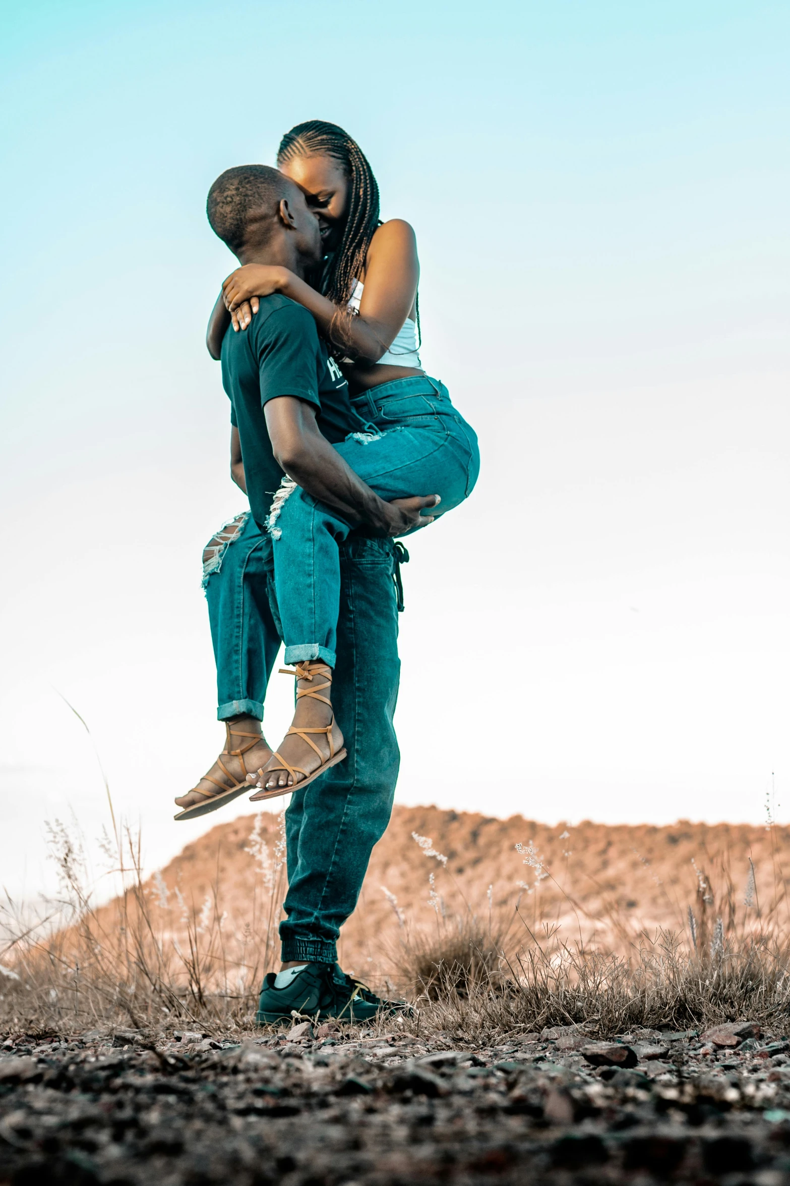 a man holding a woman up in the air