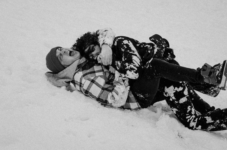 a person laying in the snow with a cell phone