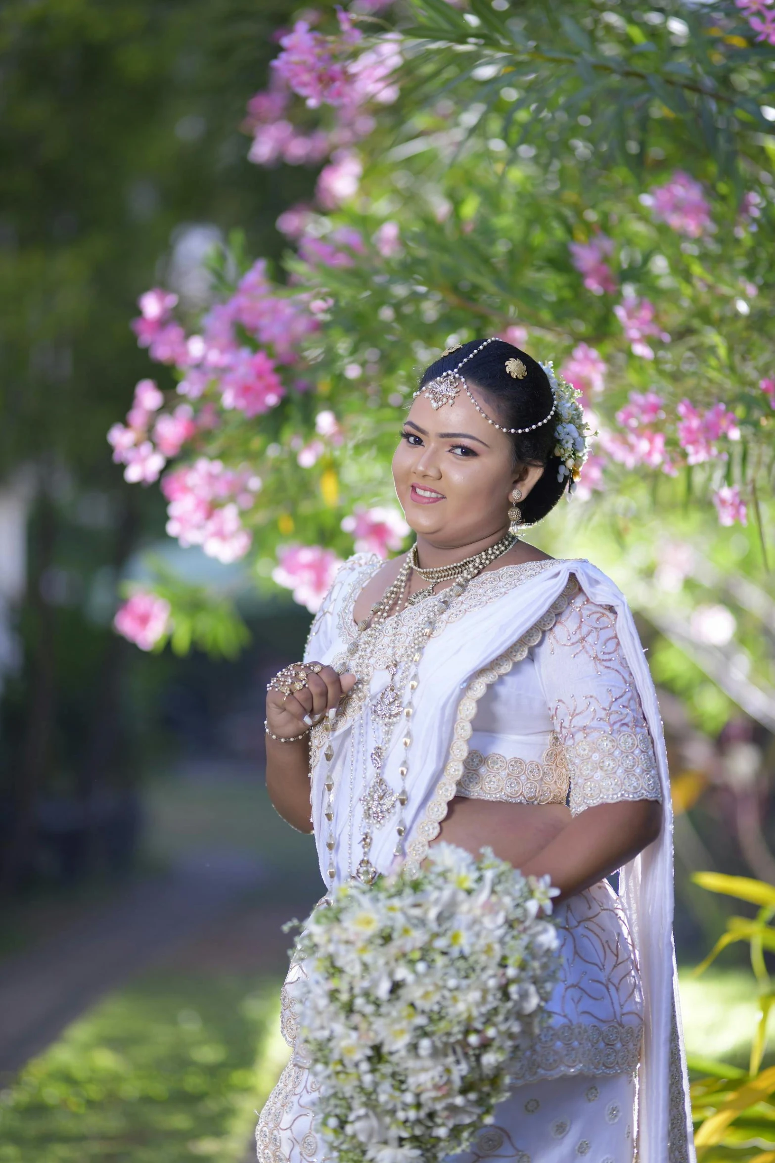 a woman in a wedding outfit poses for a po