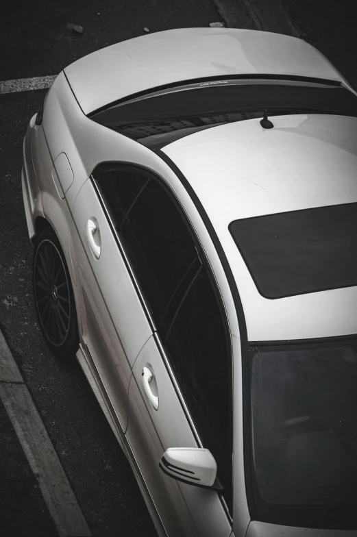 an old car with white paint is parked on a parking lot