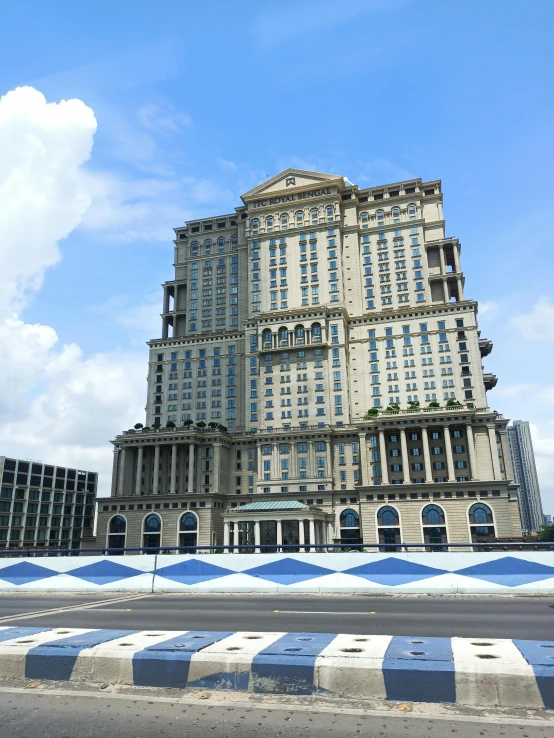 a tall building next to some buildings on a street