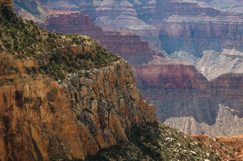 a large canyon with steep layers covered in snow