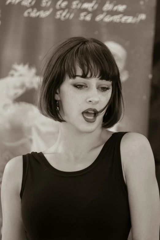 black and white pograph of a woman in black dress with fake nose rings