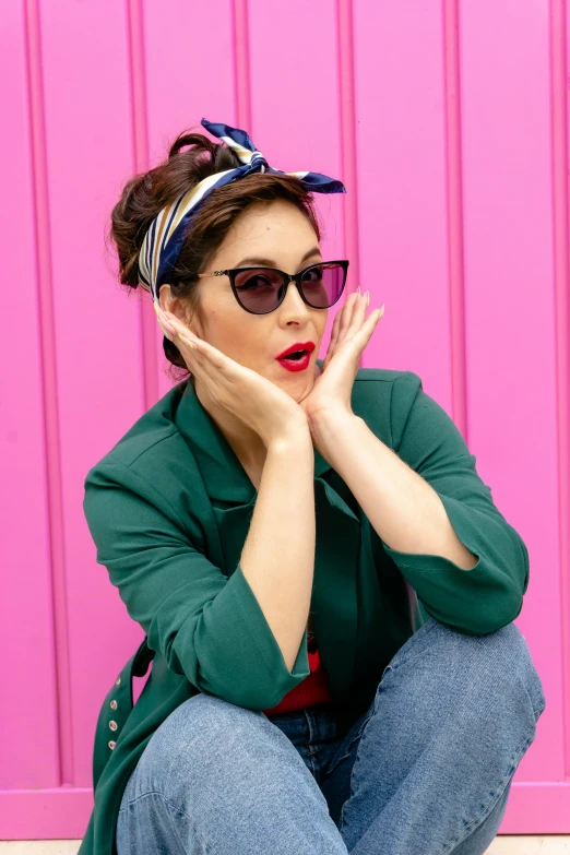 a woman sitting on the floor with her hands under her face