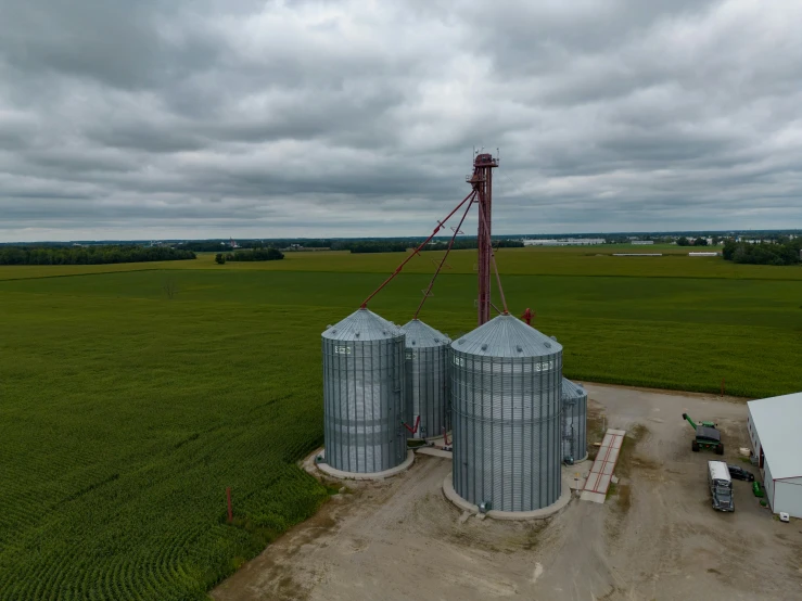 grain bins in a farm near an overcast sky