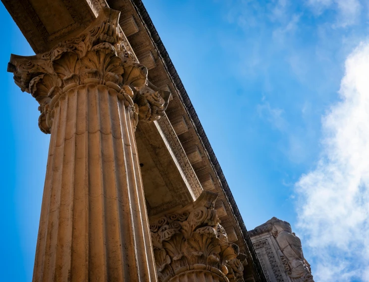 looking up at an ancient building with pillars