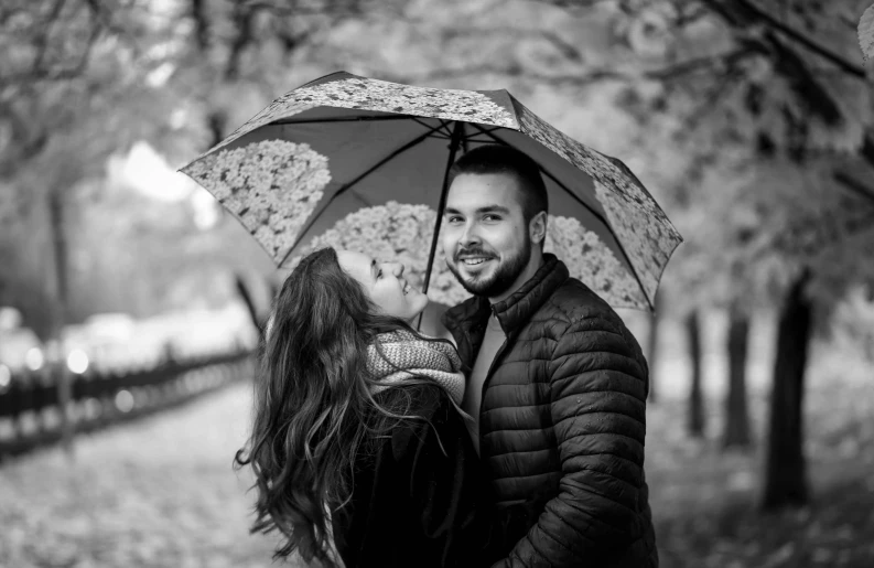 two people that are under an umbrella