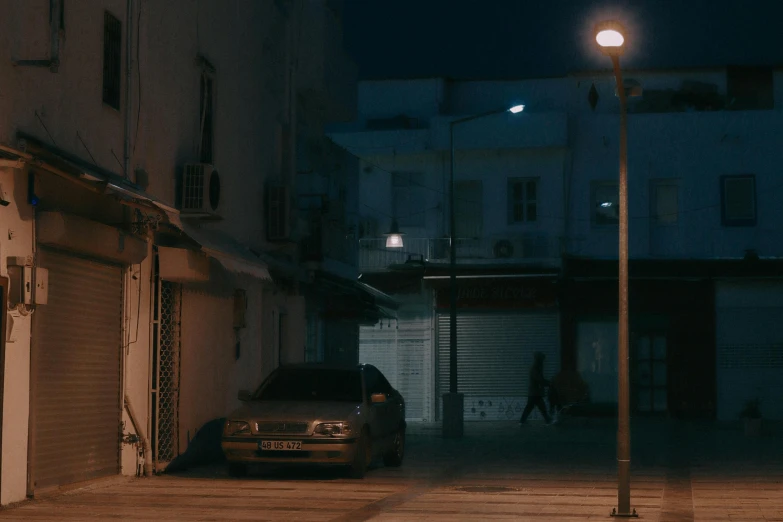 a car parked on the side of the street next to a building