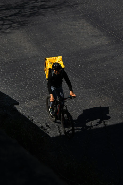 a man on a bicycle with a yellow rain coat