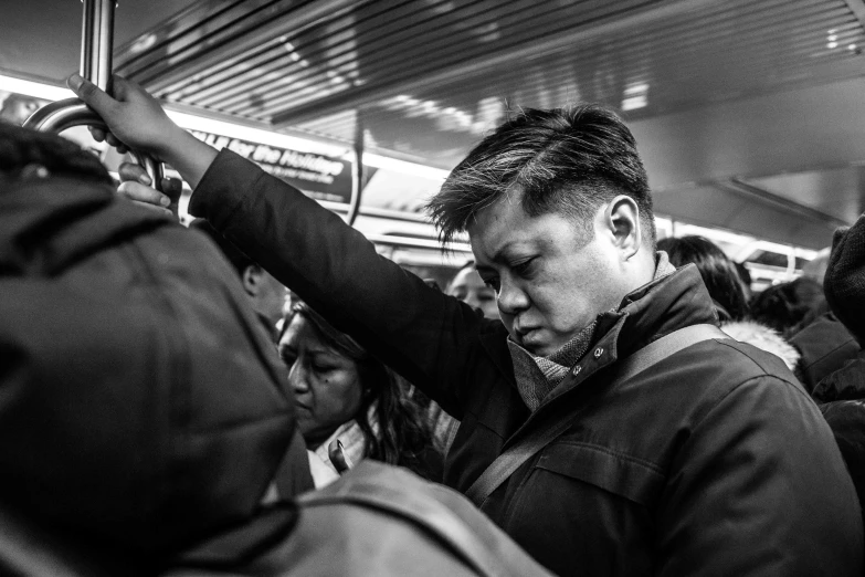 a woman is holding up her arm while waiting for a train