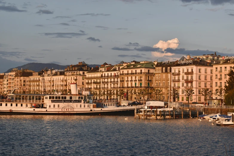 boats docked at a city pier near buildings