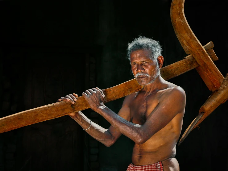 a man with a huge piece of wood in his hand
