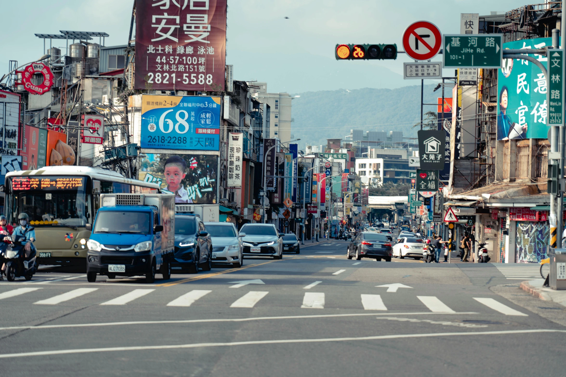 an asian street filled with traffic and buildings