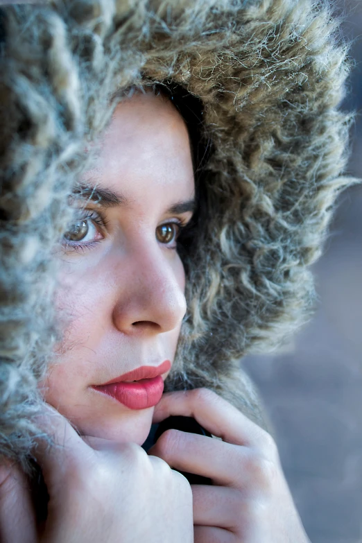 a woman with frizzy hair looks in the camera