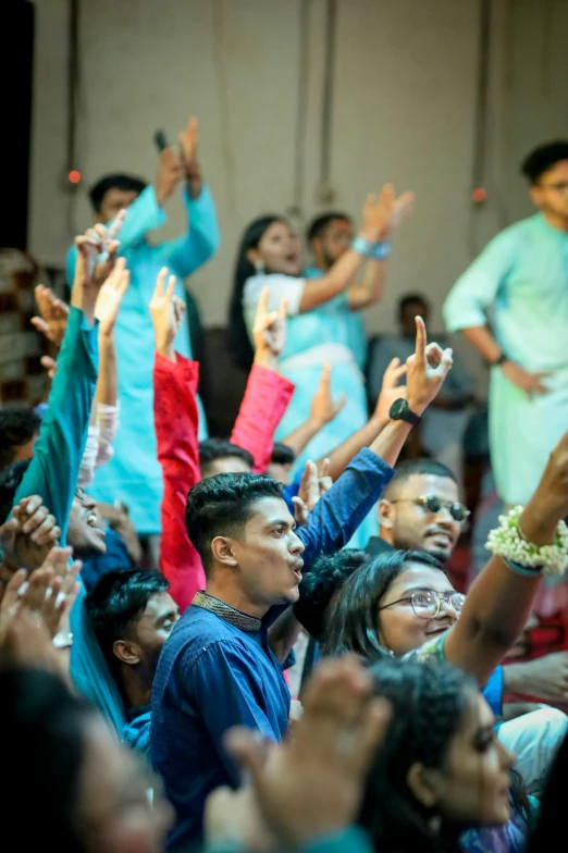 group of people waving and singing together