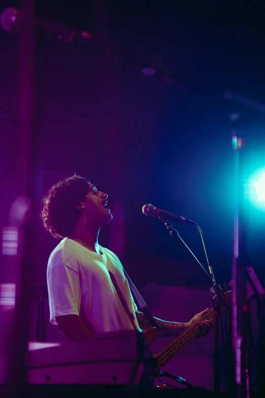 a man that is playing a bass on stage