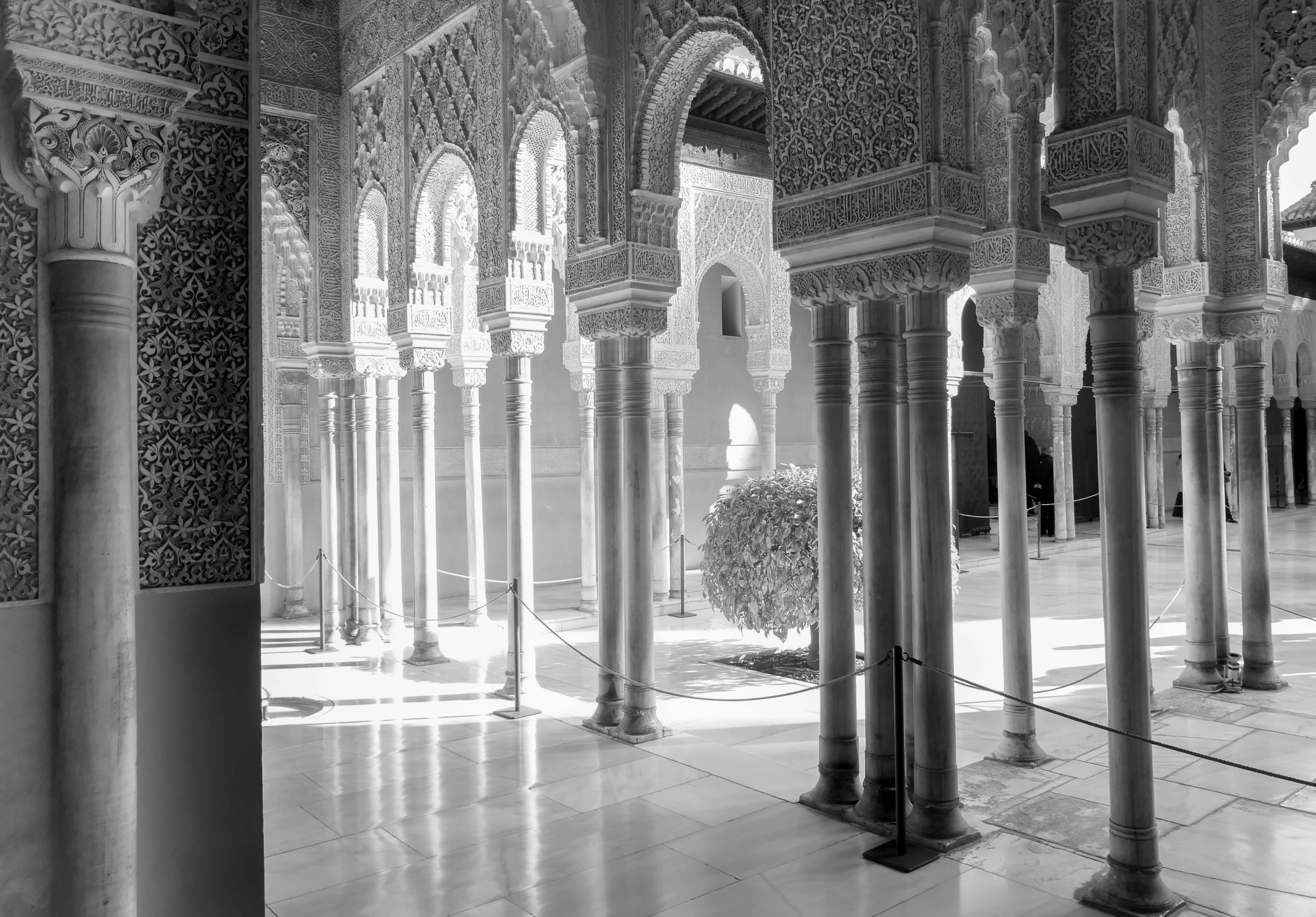 an open area with arches, pillars and a vase