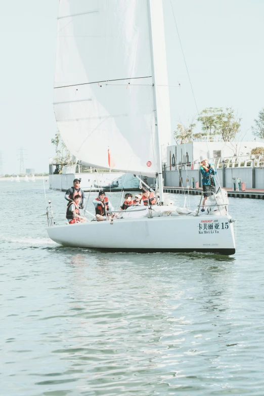 the man and woman are setting up to sail their boat