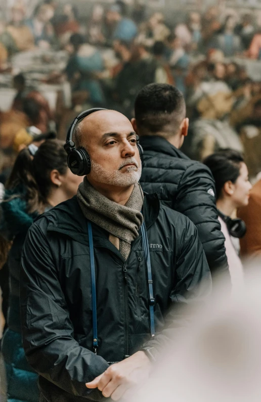 a man wearing headphones with people behind him