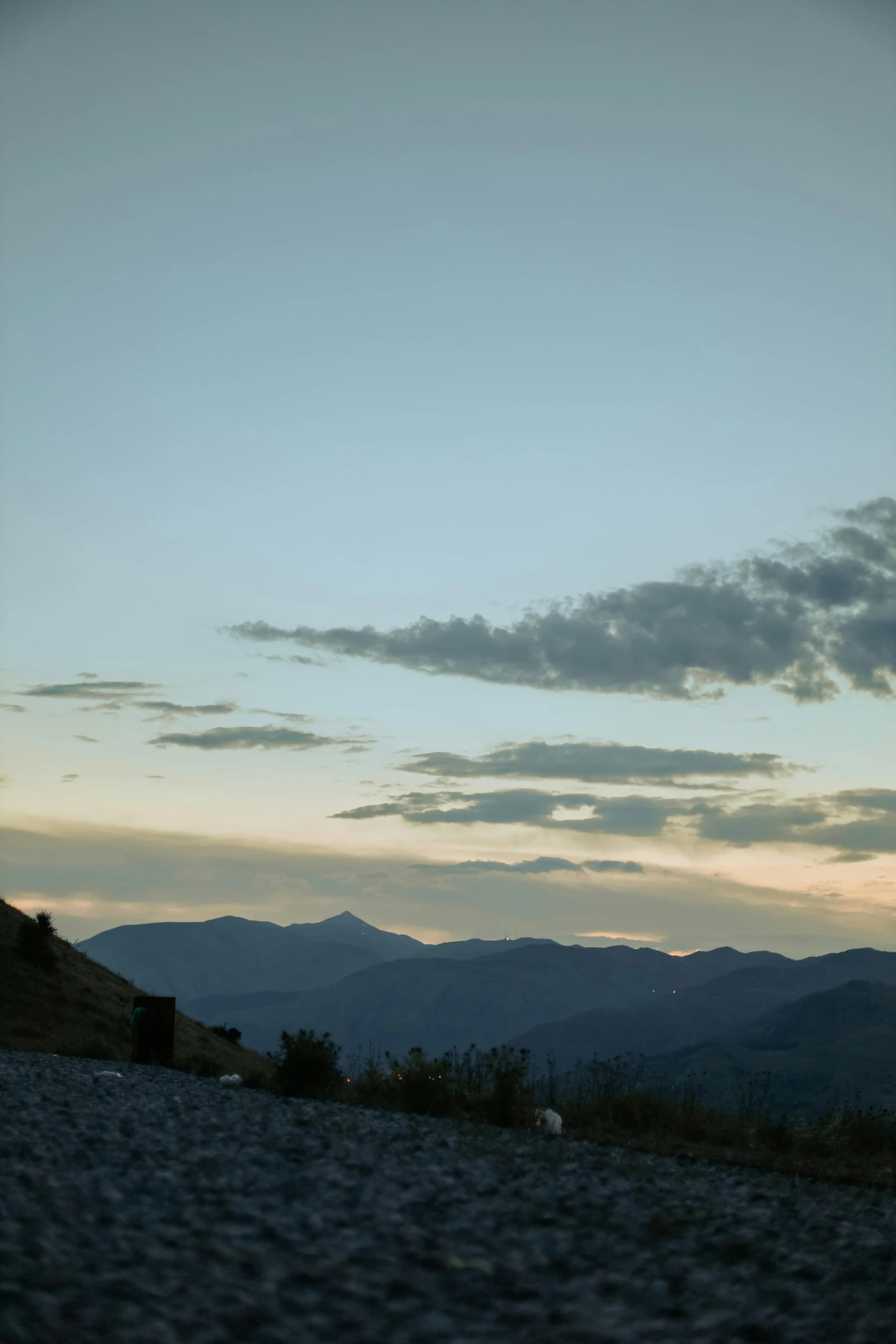 a black and white po of mountains under blue skies