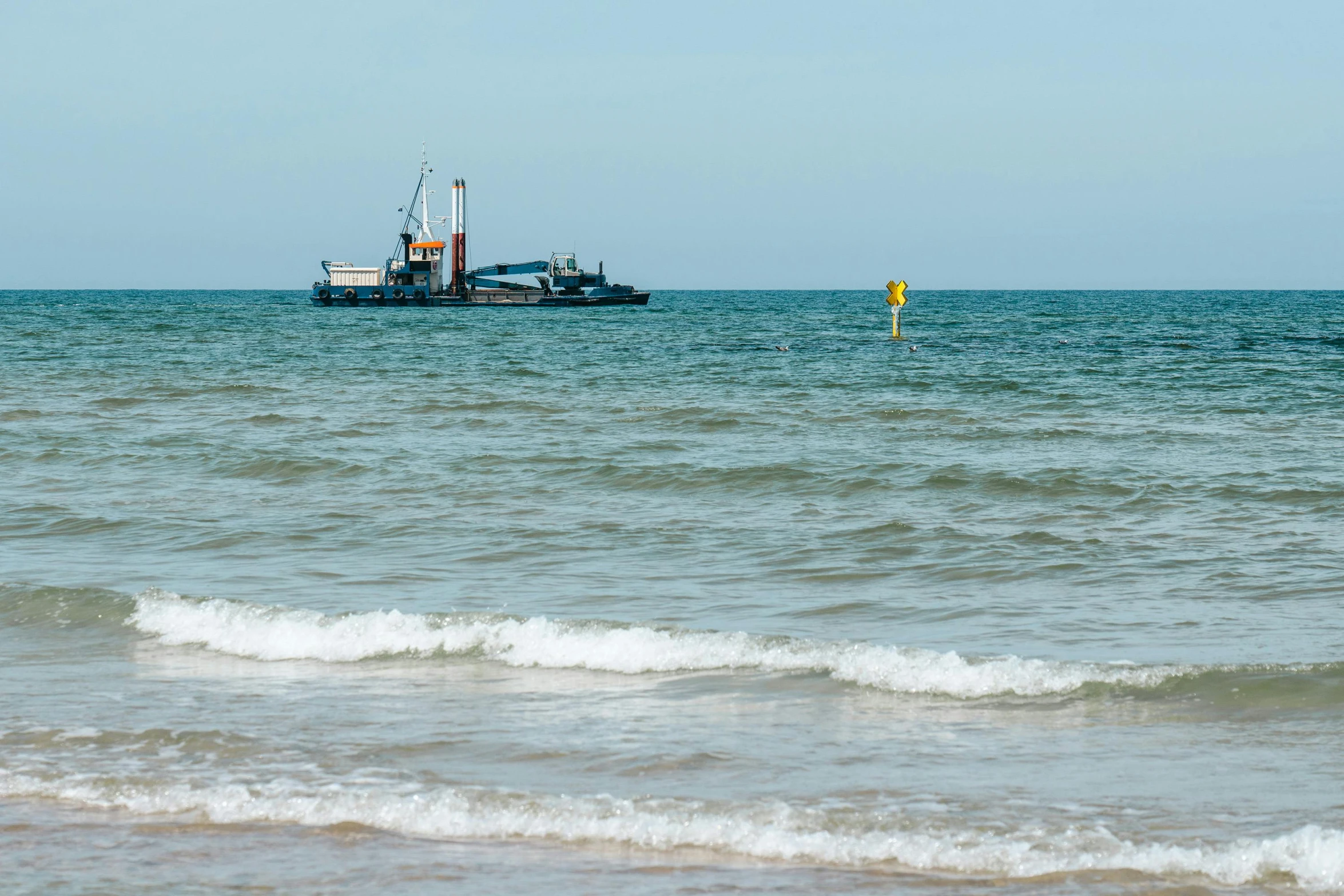 some boats are floating in the ocean water