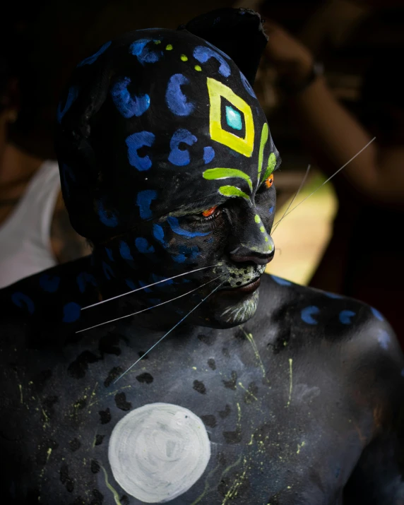 a man with makeup and paint on his face