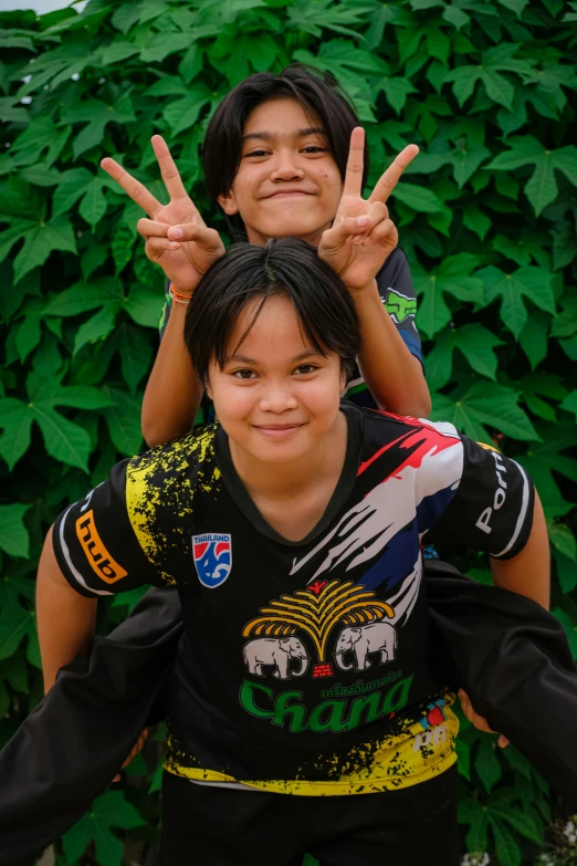 two women pose for a po while making peace signs