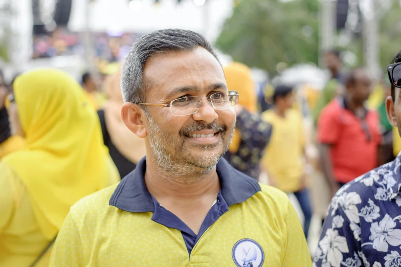 two smiling men standing in front of a crowd