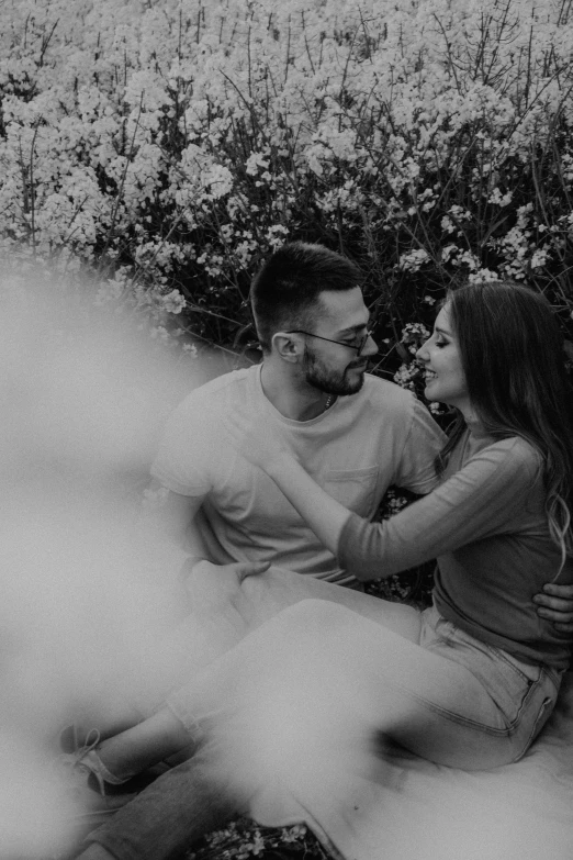 two people sitting on a bench talking