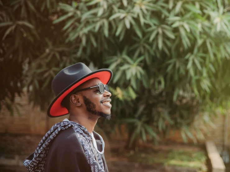 man wearing hat and scarf with outdoor trees