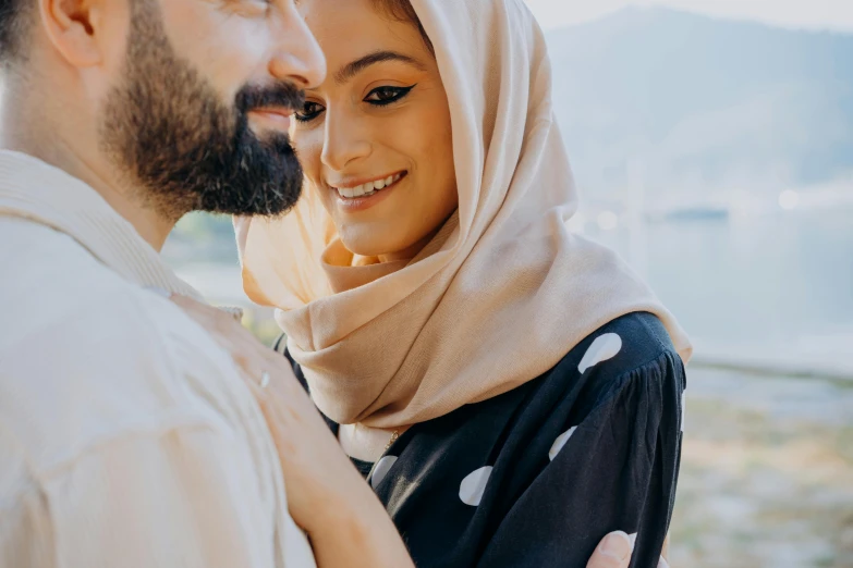 the man and woman are together smiling at each other