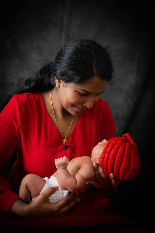 a woman holding a baby in her arms