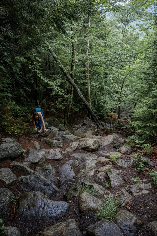 a man in black shirt on a mountain trail