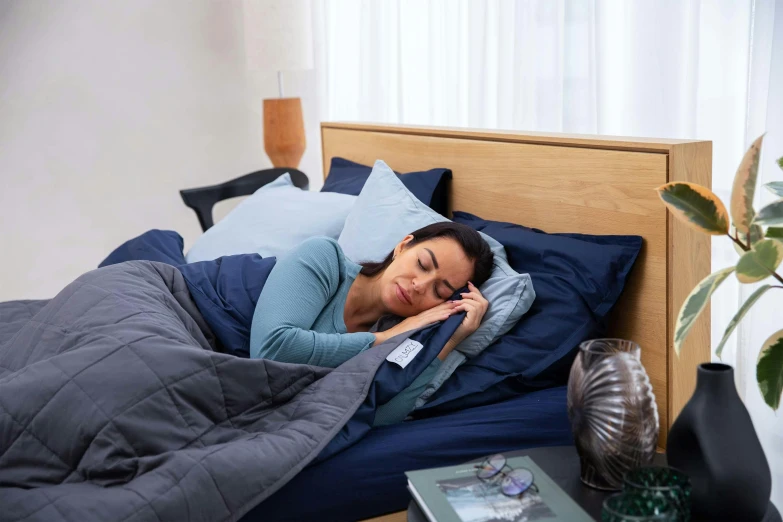 woman asleep in bed on her phone