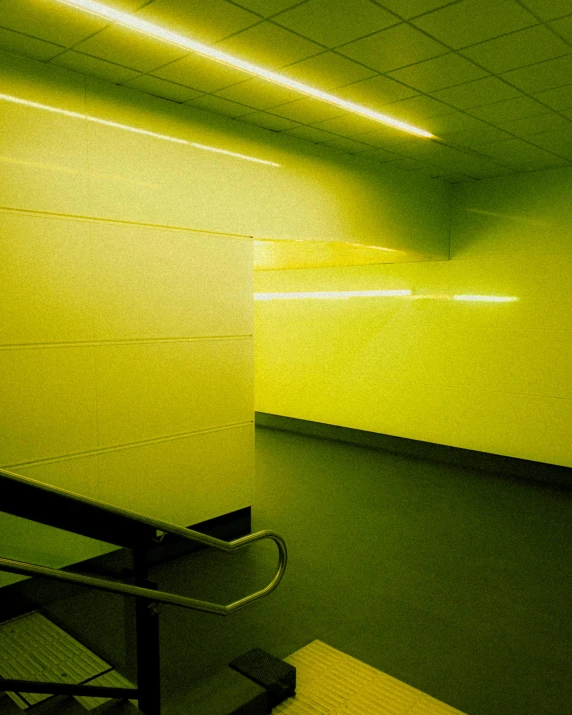 a hallway in a building with a black railing