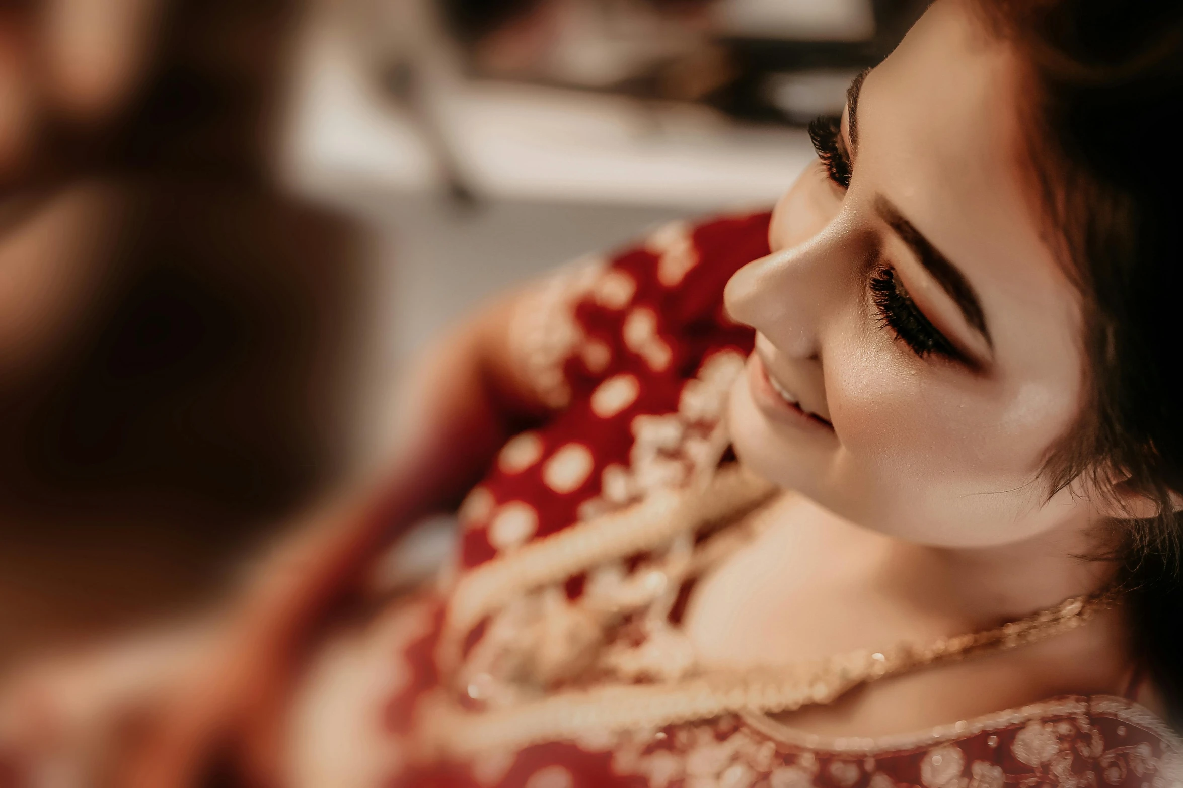 a woman in a red and white outfit with long hair and brown eyeshadow