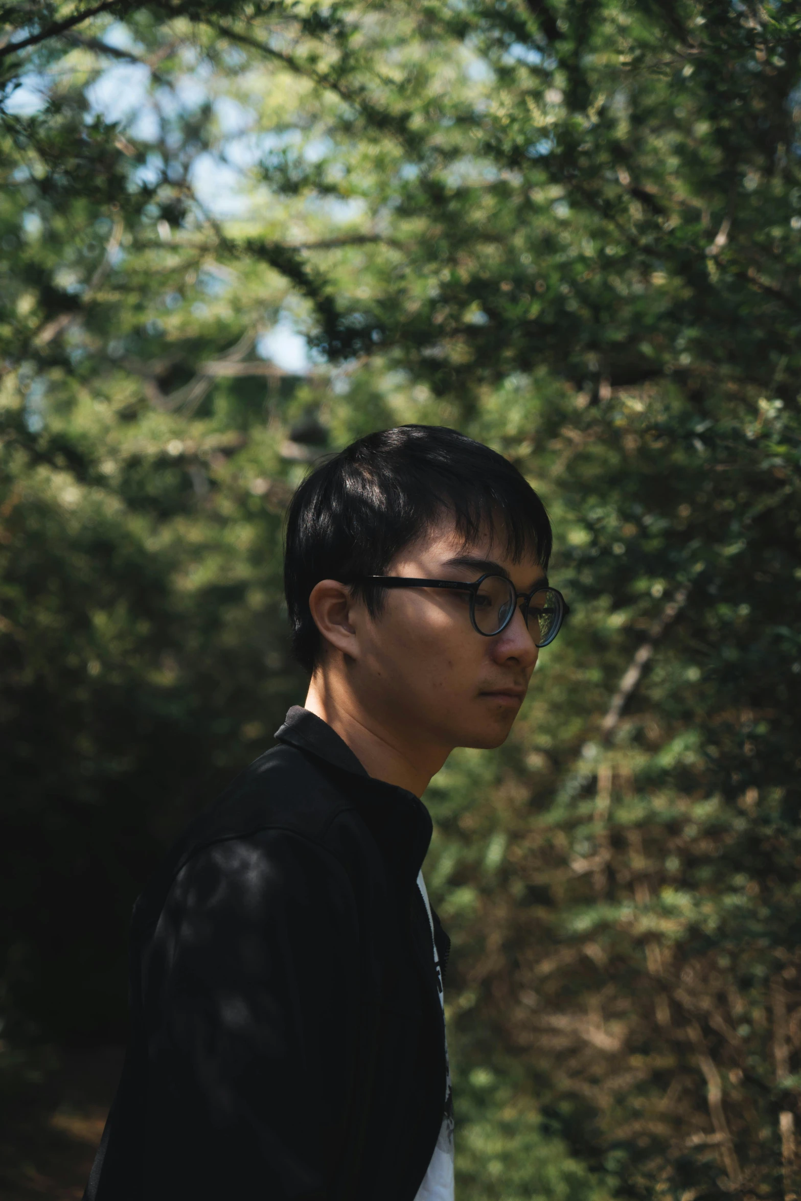 a man is standing in front of some trees