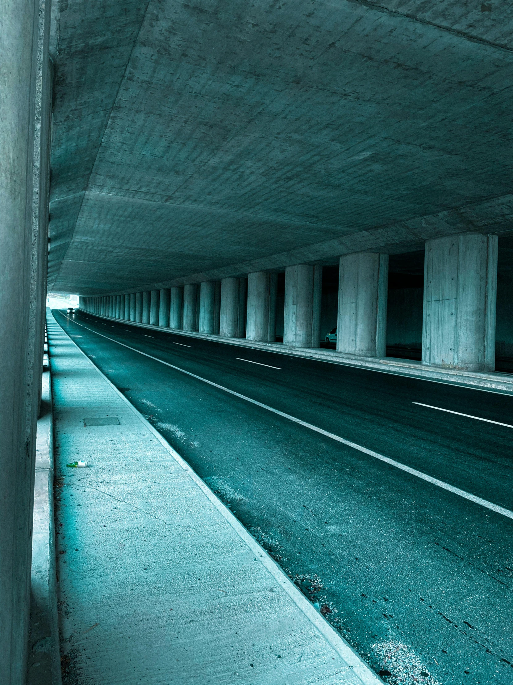 an under - ground tunnel with several cars on it