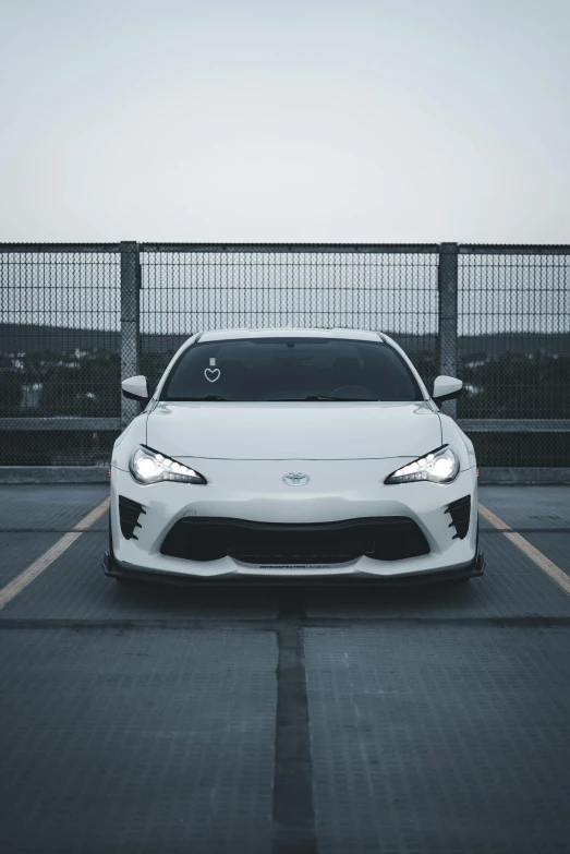 the front end of a car parked in a parking lot