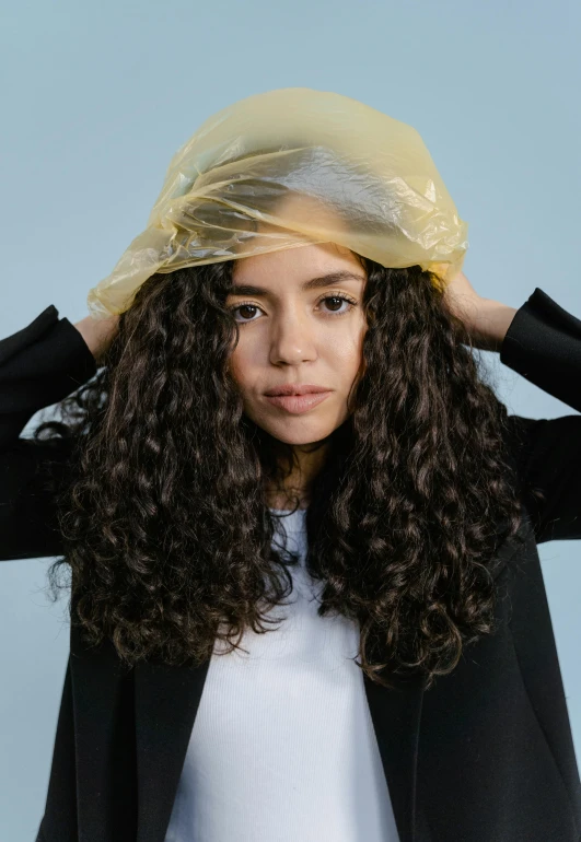 a young woman with a protective plastic covering her head