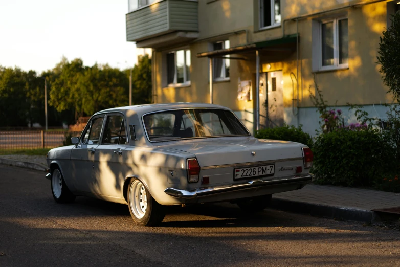 an old time car sitting on the side of a street