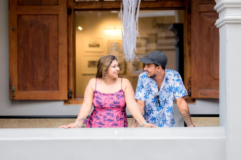 a man and woman laughing in front of a door