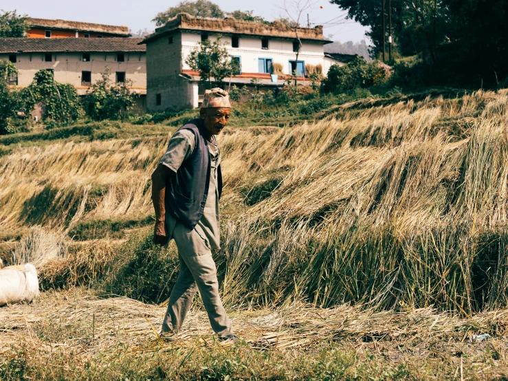 a man walking down a hill in the wilderness