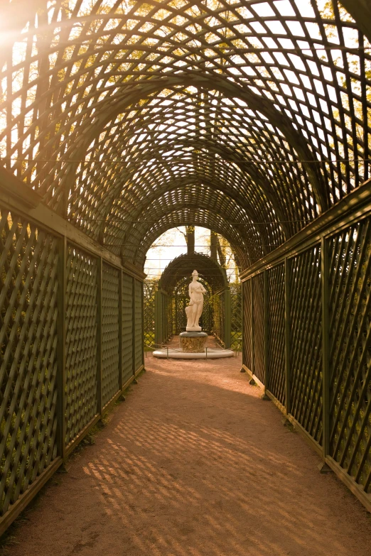 a walkway with a statue sitting in the distance