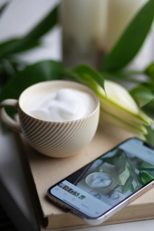 some flowers and a cup are placed on a table