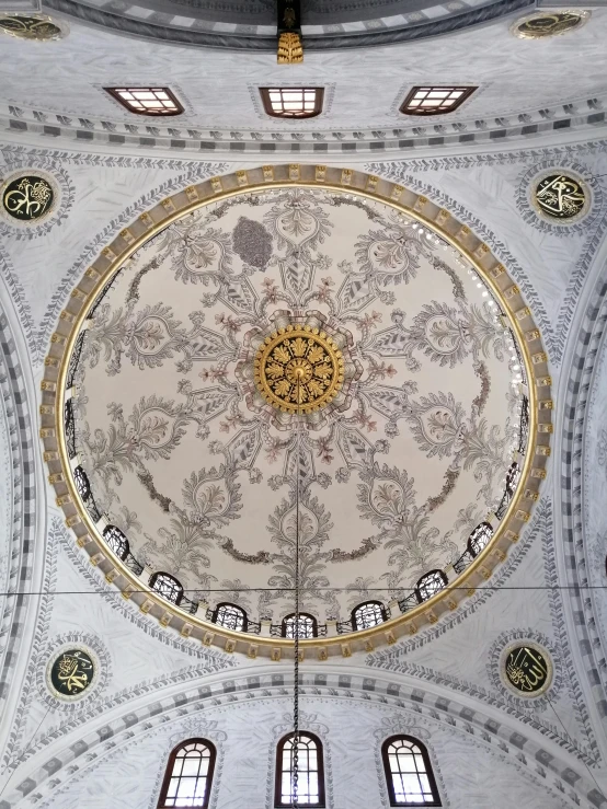 a huge, ornately decorated ceiling with windows