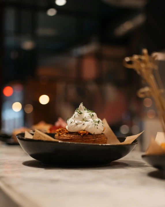 small bowl on table with various food in front